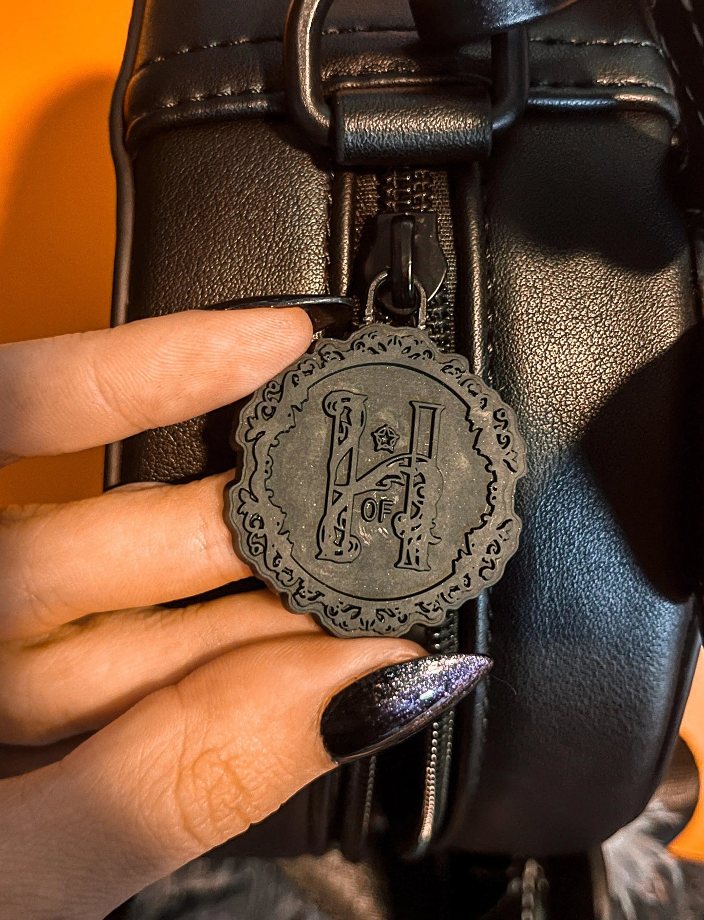 Black "H" keychain in a gothic font.