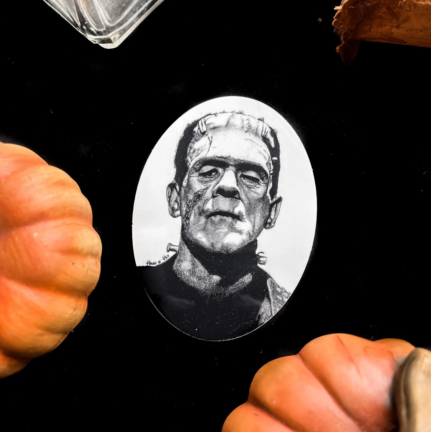 Black and white portrait drawing of Frankenstein's monster on a white sticker.