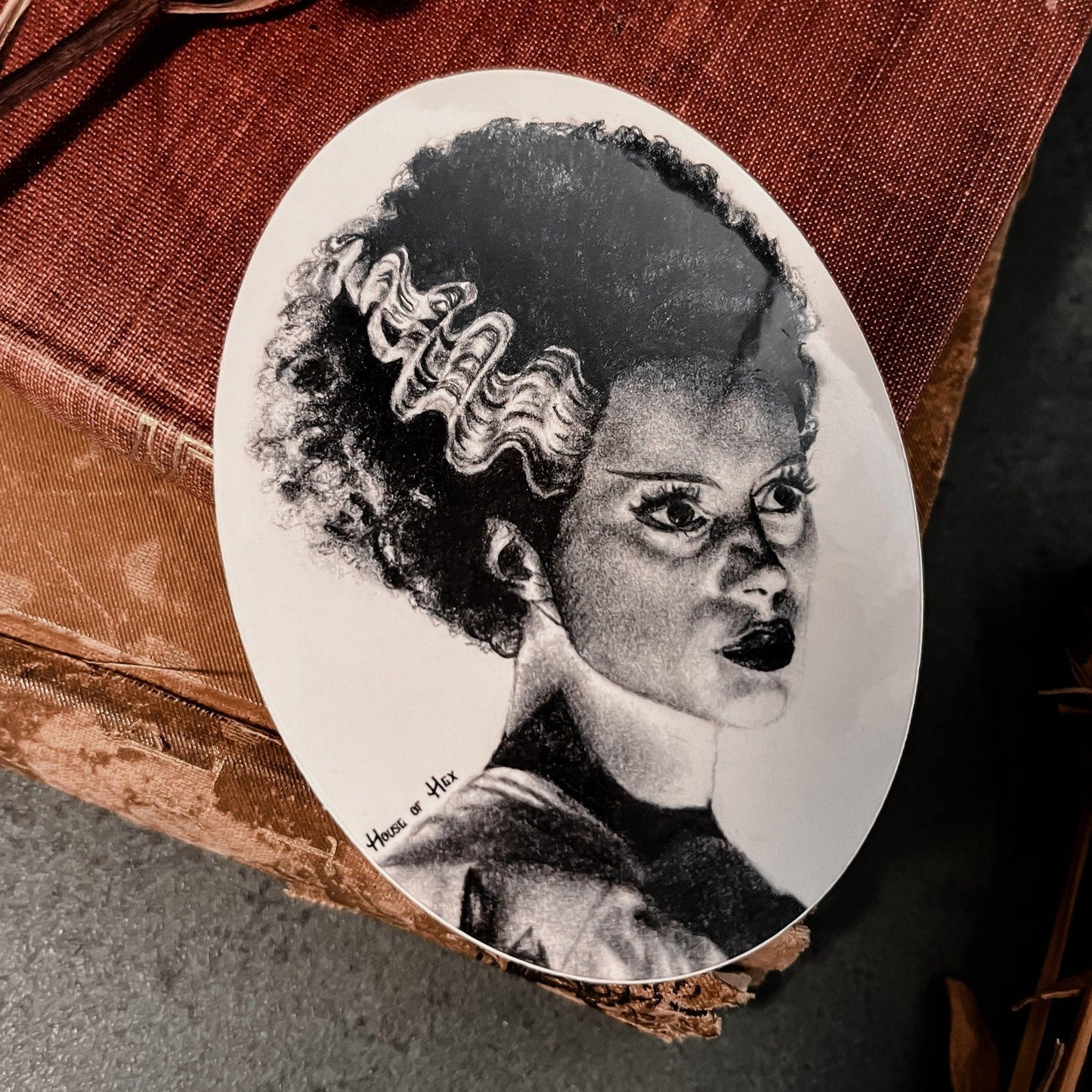 Black and white portrait drawing of the Bride of Frankenstein on a white sticker.