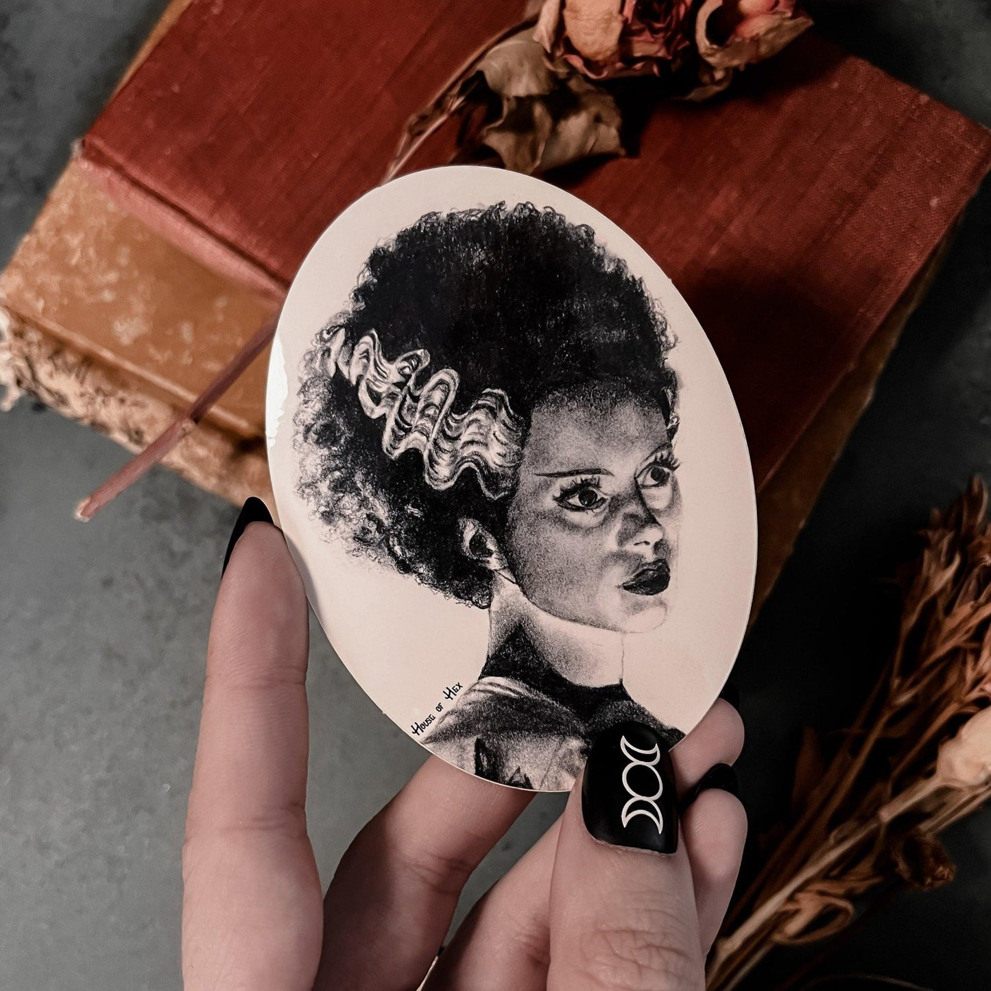 Black and white portrait drawing of the Bride of Frankenstein on a white sticker.