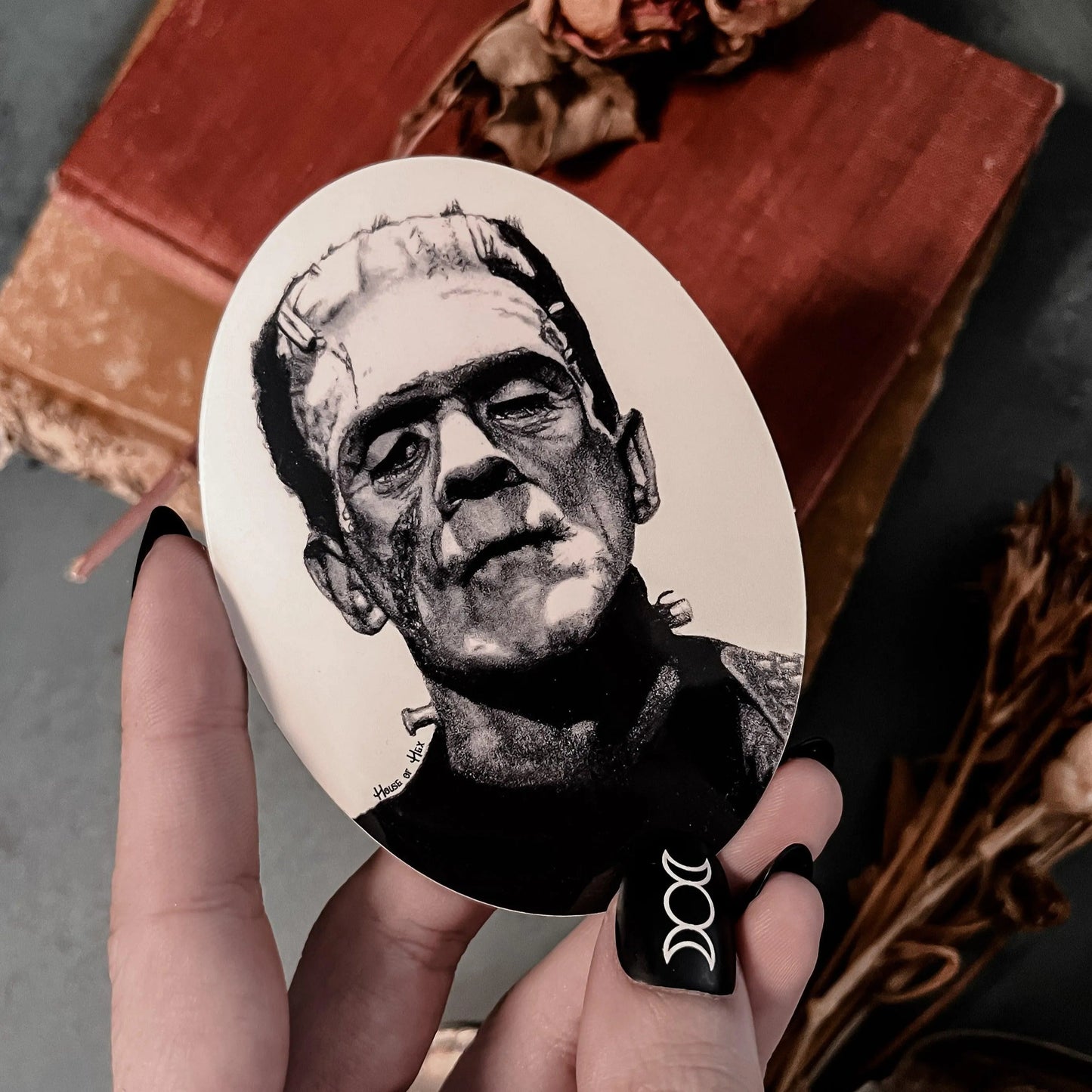 Black and white portrait drawing of Frankenstein's monster on a white sticker.