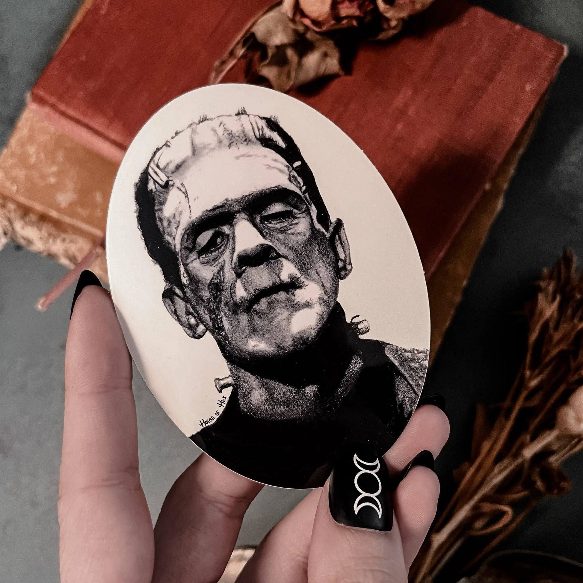 Black and white portrait drawing of Frankenstein's monster on a white sticker.