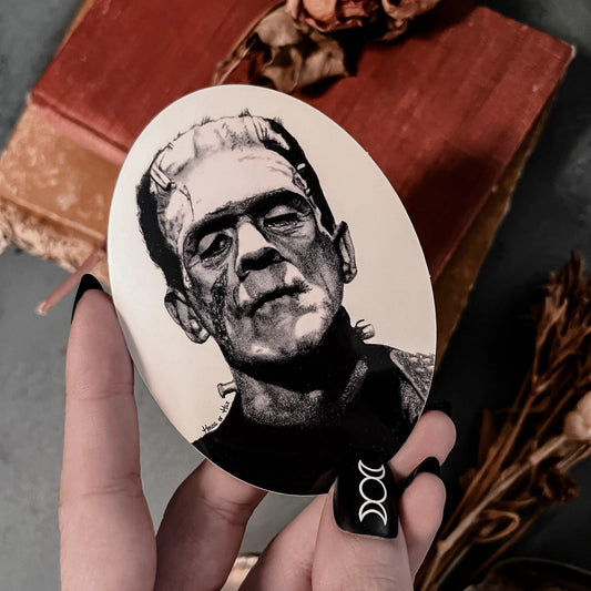 Black and white portrait drawing of Frankenstein's monster on a white sticker.