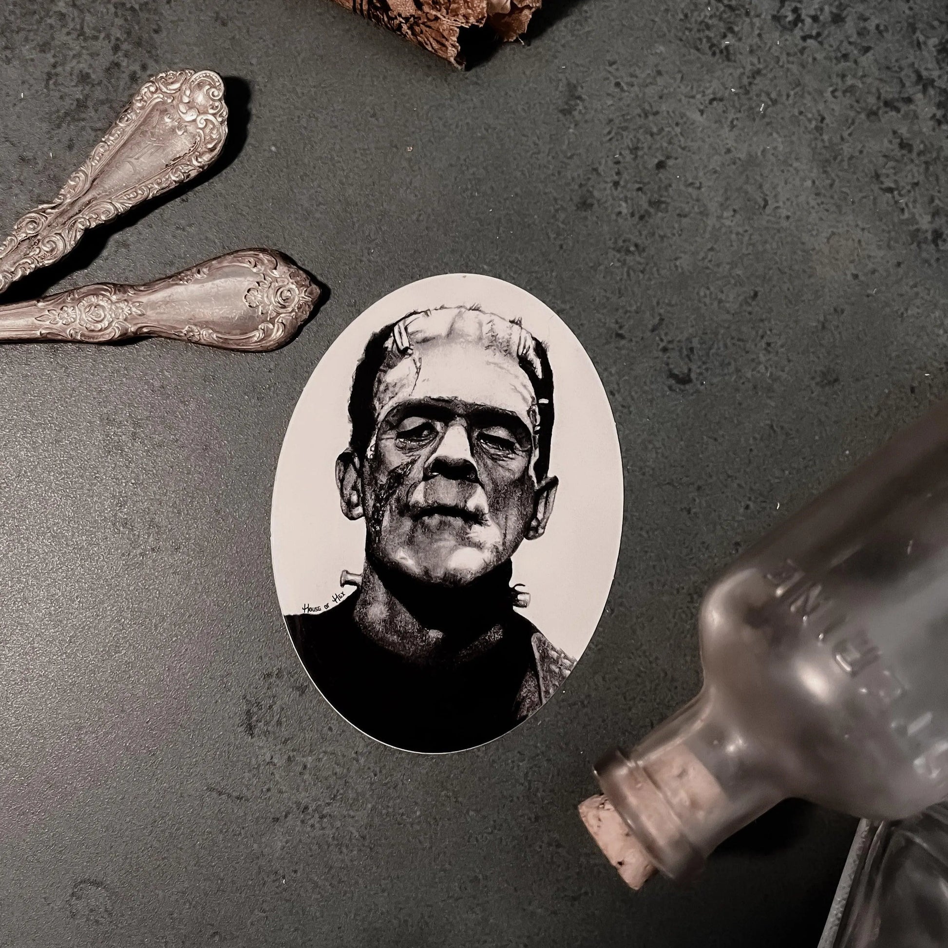 Black and white portrait drawing of Frankenstein's monster on a white sticker.
