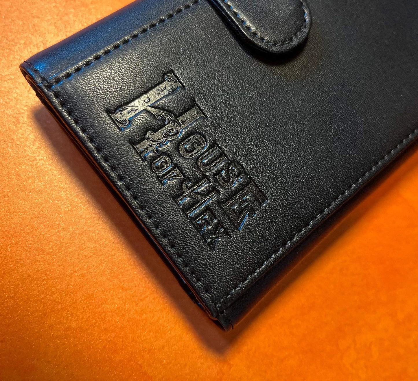 "House of Hex" on the bottom of a black wallet.