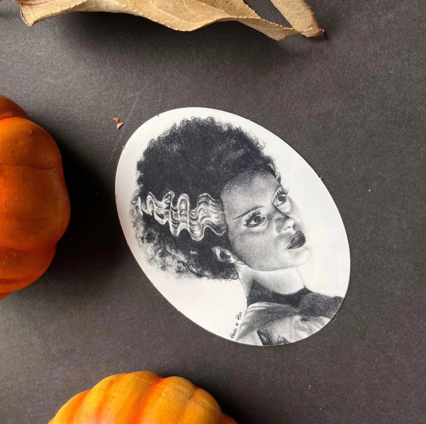 Black and white portrait drawing of the Bride of Frankenstein on a white sticker.