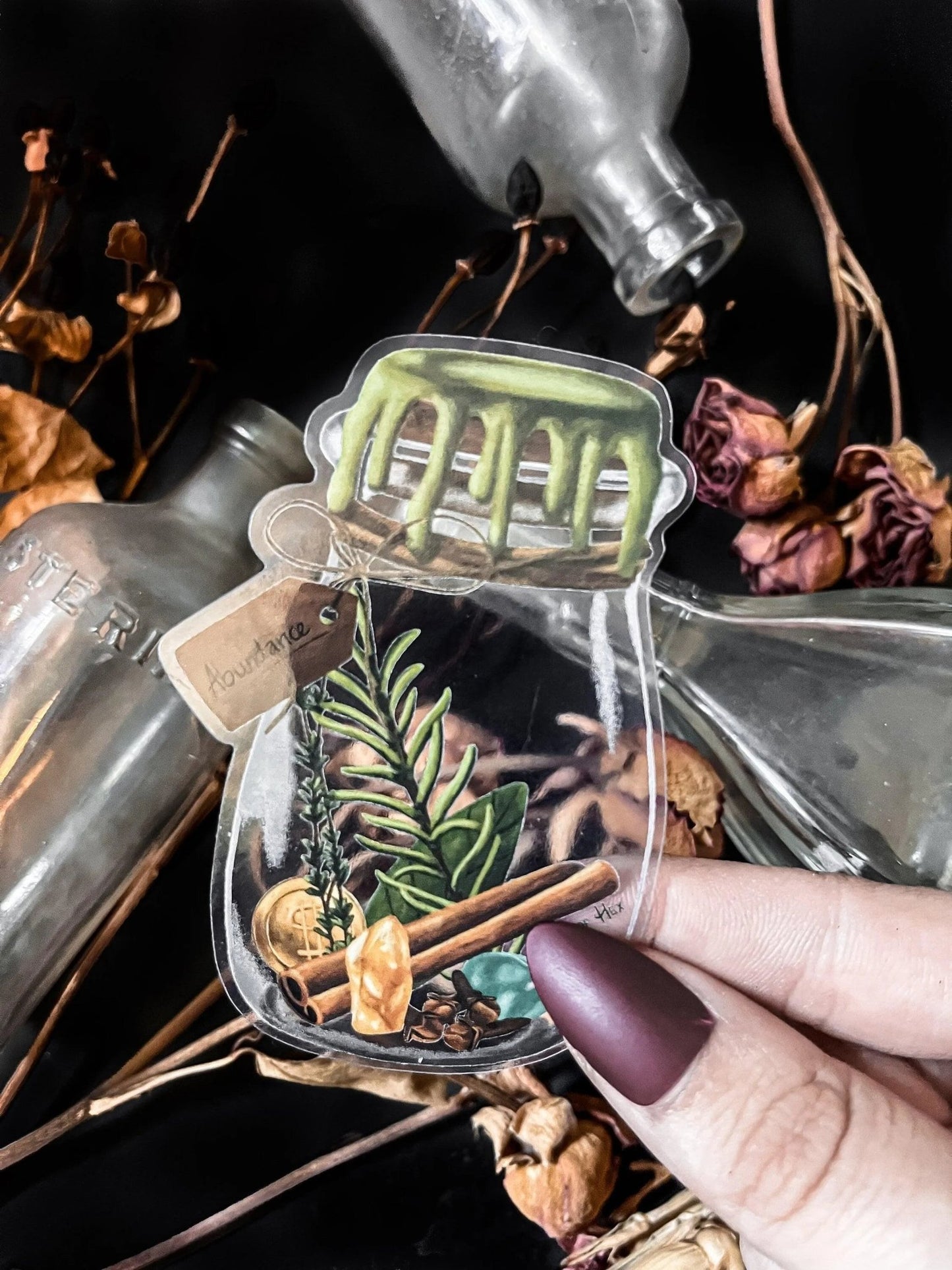 An artistic sticker illustrating a jar of herbs and spices with a tag that says "Abundance".