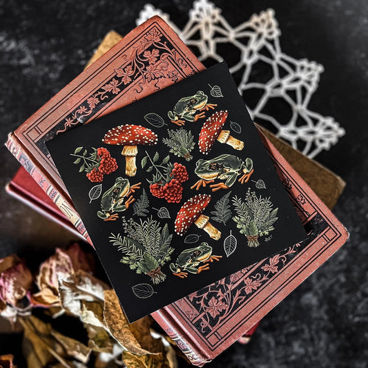 A decorative square print featuring a pattern of mushrooms, plants, and frogs on a black background.