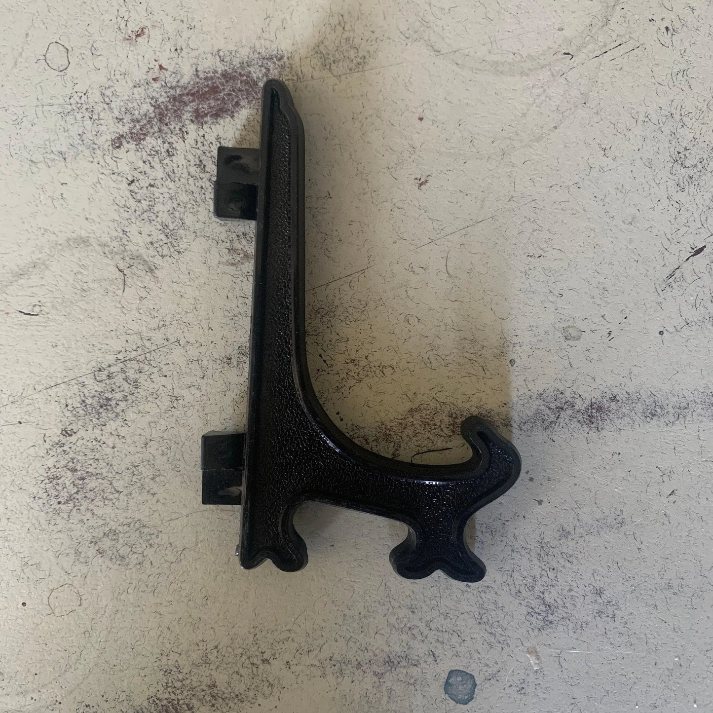 A decorative black plate stand on its side.