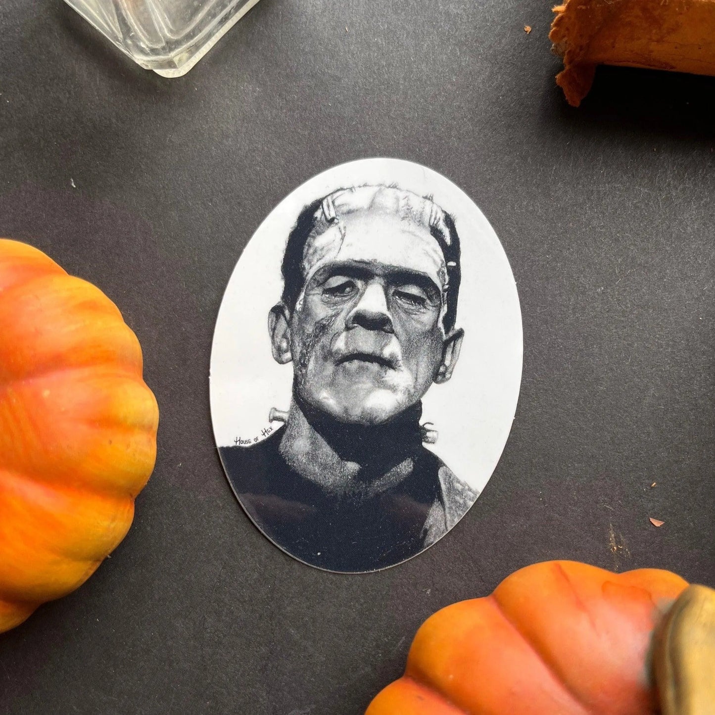Black and white portrait drawing of Frankenstein's monster on a white sticker.