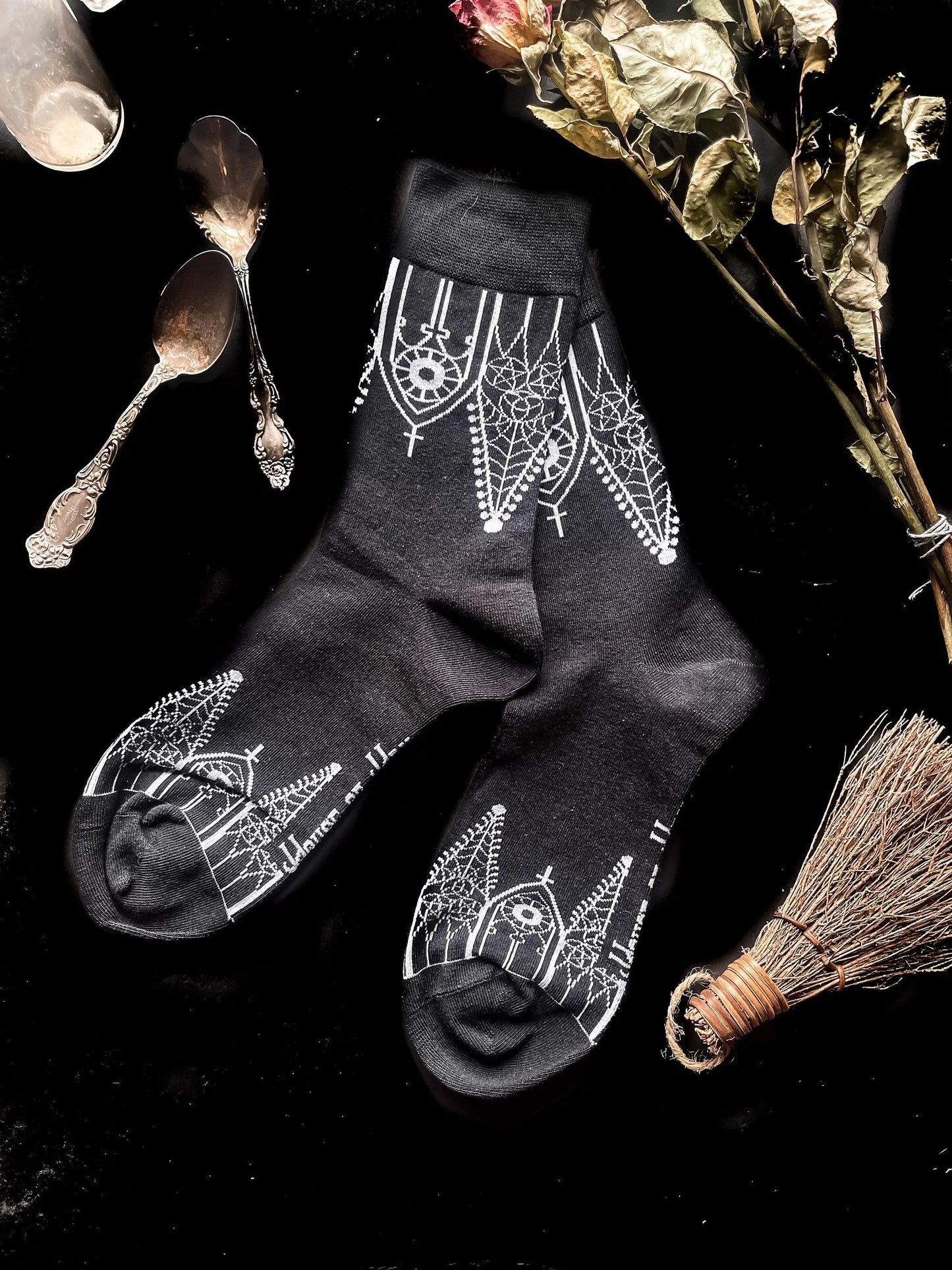 Black socks featuring gothic gables near the toe and ankles.