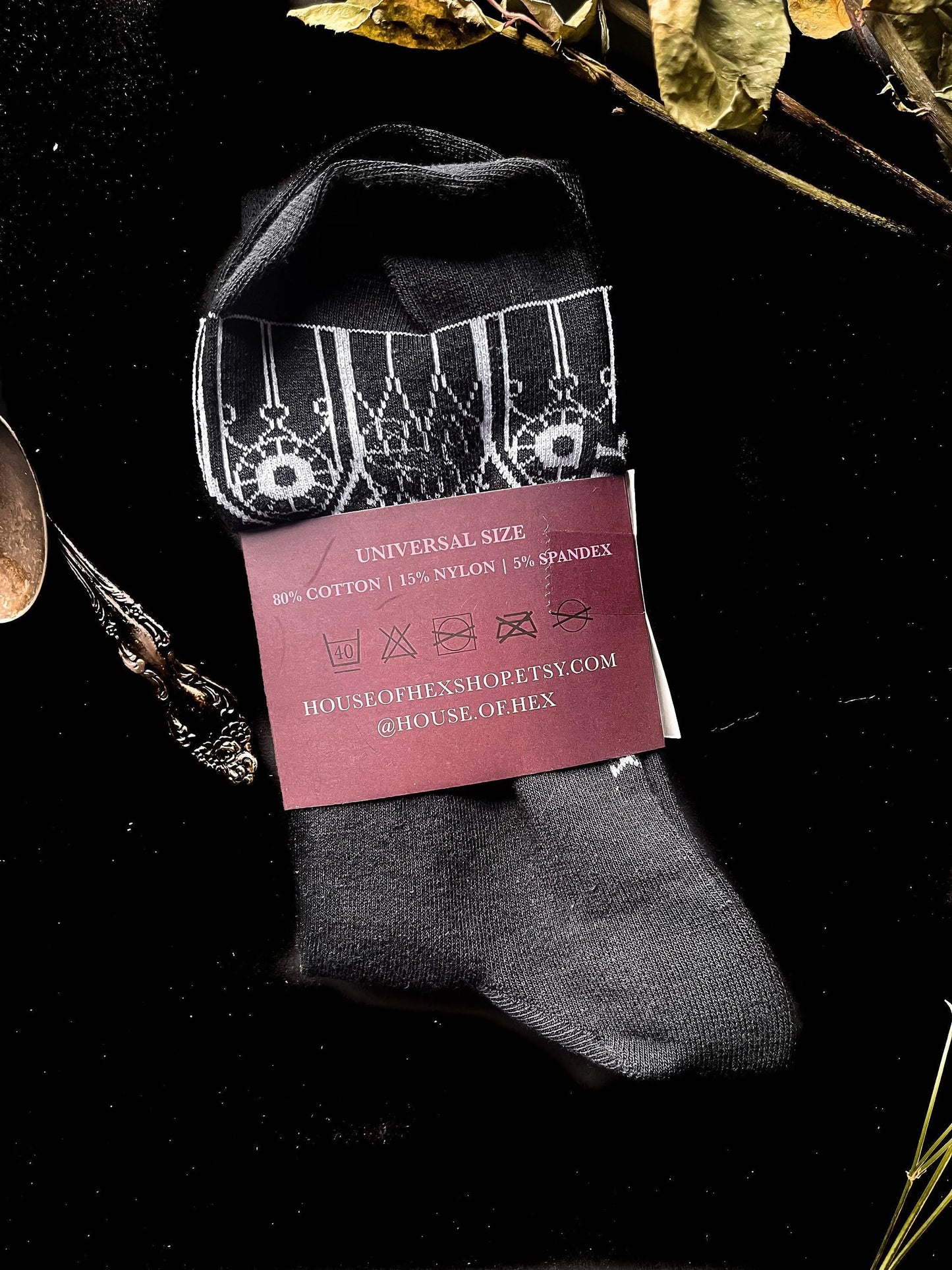 Black socks featuring gothic gables near the toe and ankles.