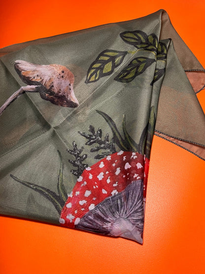 Green fabric with floral and leaf patterns on an orange background