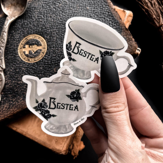 Two elegant white tea cup stickers with the word "Bestea" written in a gothic font.