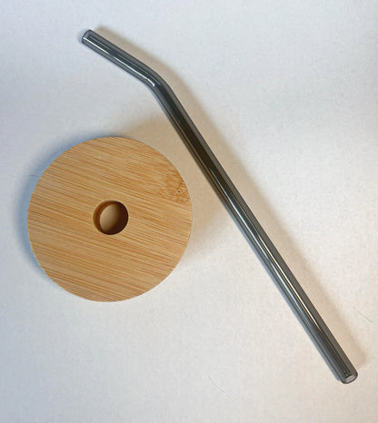 Bamboo lid and black glass straw for a drinking glass.